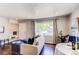 Comfortable living room featuring natural light, neutral colors, and hardwood flooring at 745 S Utica St, Denver, CO 80219