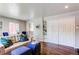 Comfortable living room with hardwood floors, stylish seating, and a view into the dining area at 745 S Utica St, Denver, CO 80219