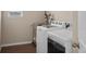 Practical laundry area equipped with a modern washer and dryer set and a metal storage rack at 17555 Lake Overlook Ct, Monument, CO 80132