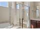 Bright main bathroom with a soaking tub, glass enclosed shower and modern finishes at 17555 Lake Overlook Ct, Monument, CO 80132