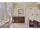 Relaxing main bathroom featuring a luxurious soaking tub, glass enclosed shower, and double vanity at 17555 Lake Overlook Ct, Monument, CO 80132