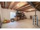 Spacious unfinished basement area, with exposed ceiling beams and a storage shelf at 8255 E 150Th Pl, Thornton, CO 80602