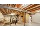 Unfinished basement with workout equipment, framed walls, and exposed ceiling at 8255 E 150Th Pl, Thornton, CO 80602