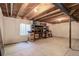 Unfinished basement with exposed ceiling, storage shelves, and small window for natural light at 8255 E 150Th Pl, Thornton, CO 80602