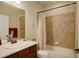 Bathroom featuring a bathtub with tile surround, a single sink, and light brown cabinets at 8255 E 150Th Pl, Thornton, CO 80602