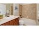 Bathroom with a tub and shower combination, and wood vanity at 8255 E 150Th Pl, Thornton, CO 80602