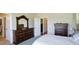 Bedroom showing the entrance to the bathroom and a decorative dresser with an elaborate mirror at 8255 E 150Th Pl, Thornton, CO 80602