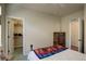 Bedroom with neutral walls with light wood furniture and a walk-in closet at 8255 E 150Th Pl, Thornton, CO 80602