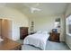 Spacious bedroom showcasing light walls, a ceiling fan, and two dressers with carpeted floors at 8255 E 150Th Pl, Thornton, CO 80602