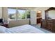 Bedroom featuring light walls and a view of the backyard trees from the window at 8255 E 150Th Pl, Thornton, CO 80602