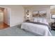 Comfortable bedroom with neutral tones, carpeted floors, and natural light from a bright window at 8255 E 150Th Pl, Thornton, CO 80602