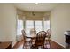 Charming breakfast nook with a round table, four chairs, and natural light from the bay window at 8255 E 150Th Pl, Thornton, CO 80602