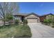 Inviting home with a two-car garage and beautifully landscaped front yard at 8255 E 150Th Pl, Thornton, CO 80602