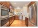 Modern kitchen with stainless steel appliances, granite countertops, and hardwood floors at 8255 E 150Th Pl, Thornton, CO 80602