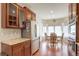 Well-equipped kitchen with stainless steel appliances, cherry cabinets, and a cozy adjacent dining area at 8255 E 150Th Pl, Thornton, CO 80602
