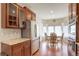 Bright eat-in kitchen featuring stainless steel appliances, granite countertops, and a dining area at 8255 E 150Th Pl, Thornton, CO 80602