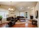 Inviting living room featuring hardwood floors, a fireplace, and stylish decor with ample seating at 8255 E 150Th Pl, Thornton, CO 80602