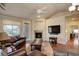 Comfortable living room with a fireplace, hardwood floors, and a large TV, perfect for entertaining at 8255 E 150Th Pl, Thornton, CO 80602