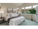 Serene primary bedroom with a king-sized bed, neutral decor, and lots of natural light at 8255 E 150Th Pl, Thornton, CO 80602
