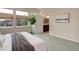 Bright main bedroom with ensuite bathroom featuring a decorative tree and neutral colors at 8255 E 150Th Pl, Thornton, CO 80602