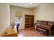 Office with a wooden desk and a piano, along with light walls and wood floors at 8255 E 150Th Pl, Thornton, CO 80602