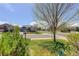 Landscaped front yard with lawn, a charming tree, and a view of the neighborhood street at 8255 E 150Th Pl, Thornton, CO 80602