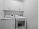 Laundry room with LG washer and dryer and cabinets at 31191 Black Eagle Dr # 102, Evergreen, CO 80439