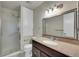 Traditional bathroom with granite vanity, large mirror, updated fixtures, and glass enclosed shower at 10116 Quivas St, Thornton, CO 80260