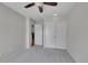 Cozy bedroom with neutral paint, fan, carpeted floors, and closet with slider doors at 10116 Quivas St, Thornton, CO 80260