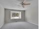 Neutral bedroom featuring soft carpet, a modern ceiling fan, and a window for natural light at 10116 Quivas St, Thornton, CO 80260