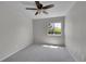 Serene bedroom featuring soft carpet, a ceiling fan and a window with tree views at 10116 Quivas St, Thornton, CO 80260