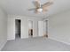 Neutral bedroom featuring soft carpet, a modern ceiling fan, and multiple closets at 10116 Quivas St, Thornton, CO 80260