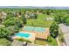 Aerial view of a community pool, tennis courts, and a green space, ideal for outdoor recreation and relaxation at 10116 Quivas St, Thornton, CO 80260