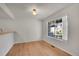 Inviting dining area with hardwood floors, a modern light fixture, and a large window at 10116 Quivas St, Thornton, CO 80260