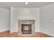 Elegant stone fireplace with an ornate iron grate, adding warmth and character to the living space at 10116 Quivas St, Thornton, CO 80260