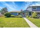 Charming blue home with a well-maintained lawn and landscaping on a sunny day at 10116 Quivas St, Thornton, CO 80260