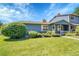 Well-manicured front lawn leading to a charming blue home with mature landscaping at 10116 Quivas St, Thornton, CO 80260