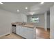 Open kitchen featuring ample counter space, stainless dishwasher, and a view to the dining room at 10116 Quivas St, Thornton, CO 80260