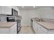 Functional kitchen area with white cabinetry, stainless steel appliances and stone countertops at 10116 Quivas St, Thornton, CO 80260