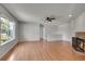 Bright and airy living room featuring hardwood floors and a stone fireplace at 10116 Quivas St, Thornton, CO 80260