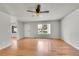 Bright living room featuring hardwood floors and a ceiling fan with a window view at 10116 Quivas St, Thornton, CO 80260