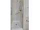 Close-up of modern walk-in shower with white tile and brushed nickel hardware, providing a clean and stylish design at 10116 Quivas St, Thornton, CO 80260