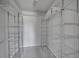 Spacious walk-in closet with metal shelving and soft carpet at 10116 Quivas St, Thornton, CO 80260