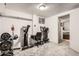 Carpeted basement featuring a home gym with weight rack and exercise equipment; bright neutral color palette at 658 S Dudley St, Lakewood, CO 80226