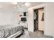 Bedroom with a closet, television, track lighting, and gray carpet flooring at 658 S Dudley St, Lakewood, CO 80226