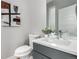 Bathroom features a white sink, toilet, gray vanity and modern fixtures at 4922 Lowell Blvd # 2, Denver, CO 80221