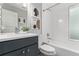 Bathroom featuring modern vanity, large mirror, shower/tub combo, and updated fixtures at 4922 Lowell Blvd # 2, Denver, CO 80221