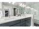 Bathroom featuring dual sinks, a walk-in shower, and modern fixtures at 4922 Lowell Blvd # 2, Denver, CO 80221