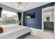 Bright bedroom features a large window, a view, and en-suite bathroom access at 4922 Lowell Blvd # 2, Denver, CO 80221