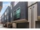 Modern townhome exteriors with gray color scheme, balconies, and attached garages at 4922 Lowell Blvd # 2, Denver, CO 80221